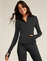 black zip-up jacket with a hoodie and thumb holes.